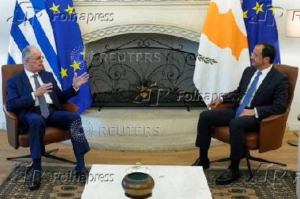 Cyprus' President Nikos Christodoulides and Greek President Constantine Tassoulas talk during a meeting at the Presidential Palace in Nicosia