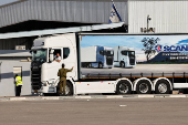 An Israeli security forces member speaks to the driver of a truck carrying aid at the Kerem Shalom crossing between Israel and Gaza, before going into Gaza, on the Israeli side of the Israel-Gaza border