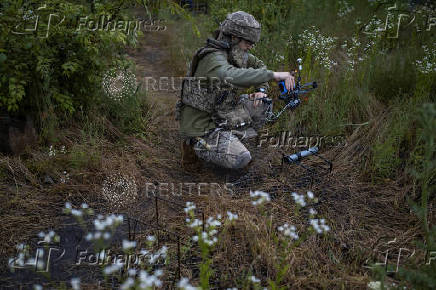 Ukrainian service member prepares an FPV-drone for flight at a position near the front line town of Kupiansk