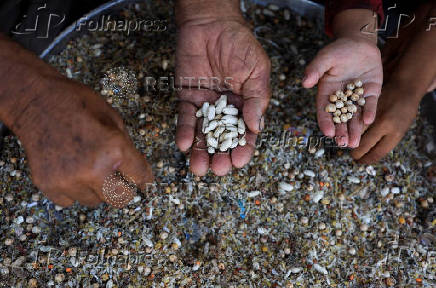 Displaced Palestinians who have not received humanitarian aid survive on leftover food, in Gaza