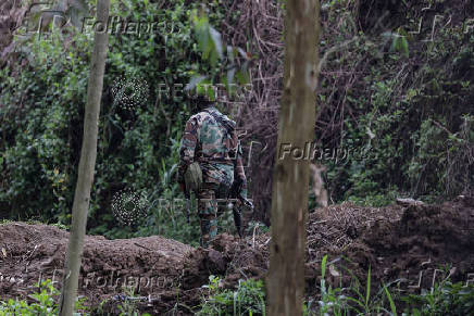 FILE PHOTO: An M23 rebel walks on the outskirts of Matanda