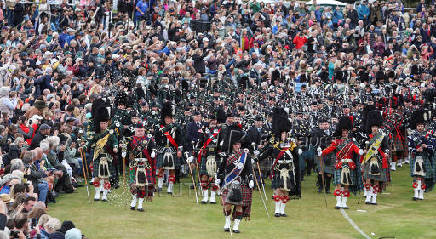 Members of a Pipe band march during the Braemar Royal Highland Gathering at the Princess Royal and Duke of Fife Memorial Park in Braemar