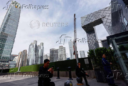 People rest at Central Business District (CBD) in Beijing