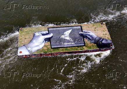 Drone view shows a grass covered barge with painting by Franco-Swiss artist Saype entitled 