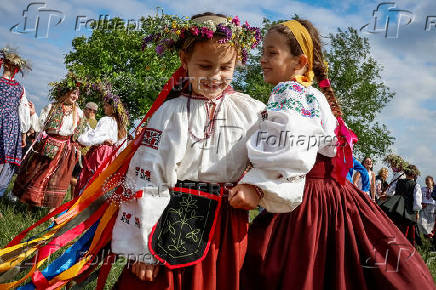 People take part in a celebration on the traditional Ivana Kupala in the village of Vytachiv, in Kyiv region