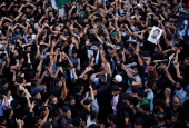 Shi'ite mourners raise their hands and shout slogans during a Muharram procession ahead of Ashura in Srinagar