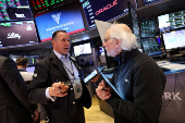 Traders work on the floor at the New York Stock Exchange, in New York City