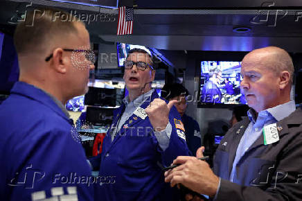 Traders work on the floor of the NYSE in New York