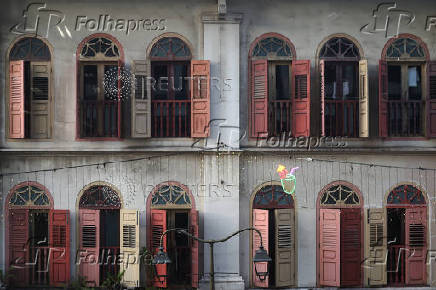 A view of wooden windows on a conserved Chinese shophouse in Chinatown, Singapore