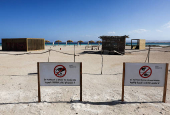 View of signs surrounded with a barrier made of wooden sticks in front of Ras Hankorab beach in Wadi el-Gemal National Park, at southern Egypt's Red Sea coast in Marsa Alam