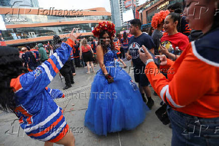 Edmonton Oilers fans react in a fan zone during the first game of the Stanley Cup Finals against the Florida Panthers, in Edmonton