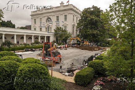 Workers reconstruct the Rose Garden to pavement at the White House