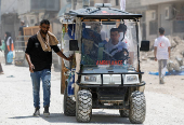 Palestinians carry their belongings after Israel's decision to demolish their homes in Nur Shams camp