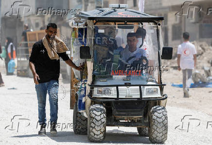 Palestinians carry their belongings after Israel's decision to demolish their homes in Nur Shams camp