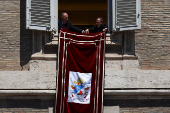 Pope Leo XIV leads the Regina Caeli prayer from his window in St. Peter's Square, at the Vatican