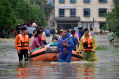 Members of NDRF team evacuate patients, attendants and medical staff from the flood-affected Jawaharlal Nehru Institute of Medical Sciences hospital, following heavy rains in Imphal East