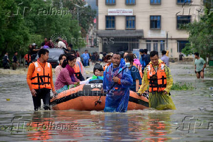 Members of NDRF team evacuate patients, attendants and medical staff from the flood-affected Jawaharlal Nehru Institute of Medical Sciences hospital, following heavy rains in Imphal East