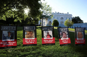 Posters of people described as arrested illegal immigrants are displayed outside the White House in Washington