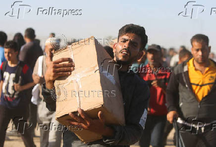 Palestinians receive aid from the U.S.-backed Gaza Humanitarian Foundation, in Khan Younis