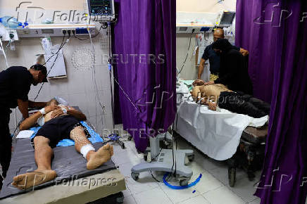 Palestinians, wounded in an Israeli strike, receive treatment, in Khan Younis