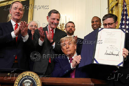 U.S. President Trump signs a resolution at the White House