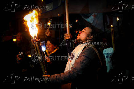 Argentine university teachers and students hold torches during a protest against Argentine President Javier Milei's education budget, in Buenos Aires