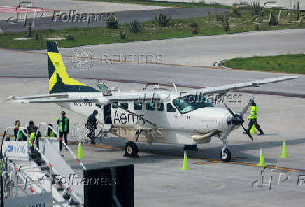 Passengers board an Aerus airline plane on the day Aerus launched a new direct route between Felipe Angeles International Airport (AIFA) and Ciudad Victoria