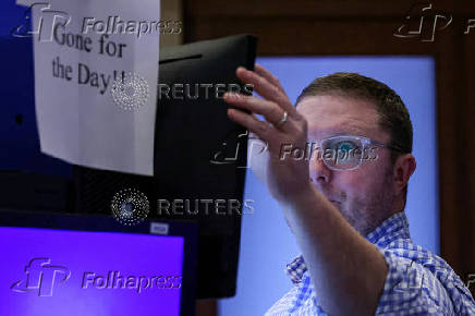 Traders work on the floor of the NYSE in New York