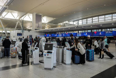 Travellers are seen at the Delta Airlines check-in area at John F. Kennedy International Airport (JFK) in New York City