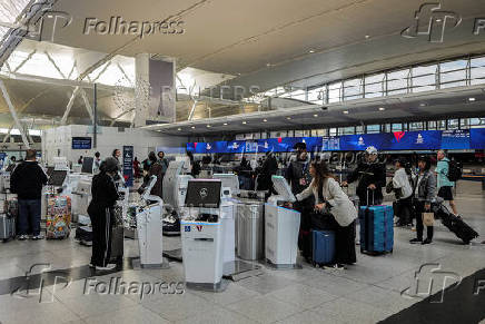 Travellers are seen at the Delta Airlines check-in area at John F. Kennedy International Airport (JFK) in New York City
