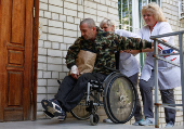 Medics assist a Ukrainian prisoner of war as he returns after a swap in an undisclosed location in Ukraine