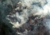 A satellite image shows smoke rising from Shoe Fire burning near Little Bear Lake, in Saskatchewan
