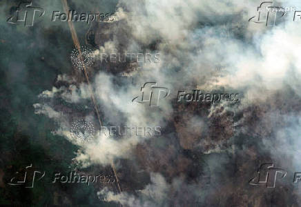 A satellite image shows smoke rising from Shoe Fire burning near Little Bear Lake, in Saskatchewan