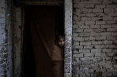 Girl watches from entrace of home during acrificial slaughter in Lahore