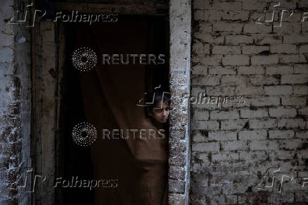 Girl watches from entrace of home during acrificial slaughter in Lahore