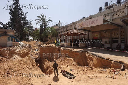 An Israeli soldierstands near the entrance to a tunnel run underneath the European Hospital in Khan Younis at the Gaza Strip