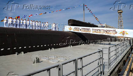 Crew members line up during a ceremony of raising a naval flag aboard the Knyaz Pozharsky nuclear-powered ballistic missile submarine in Severodvinsk