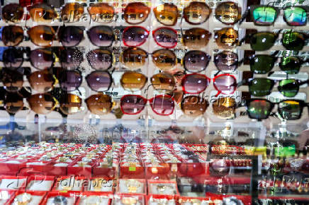 A vendor sits at his stall inside a market, in Dong Dang township