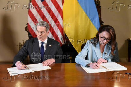U.S. Treasury Secretary Bessent and Ukrainian First Deputy Prime Minister Svyrydenko sign a deal in Washington
