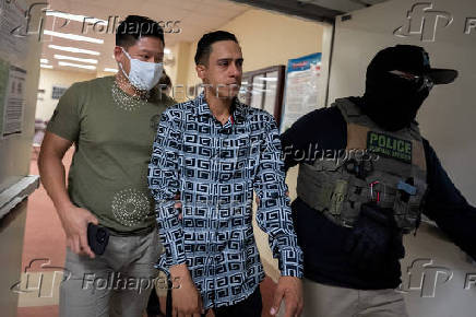 A migrant is detained by federal immigration officers at U.S. immigration court in Manhattan