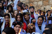 Iraqi Yazidis attend a ceremony on the occasion of Red Wednesday, to celebrate the Yazidi New Year, at Lalish temple in Shekhan District near Duhok province