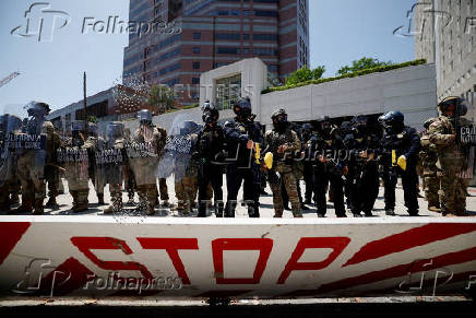 California National Guard troops stand outside the Edward R. Roybal federal building, in Los Angeles
