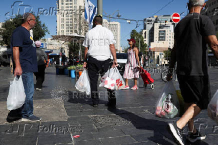 People shop in Jerusalem following an Israeli strike in Iran