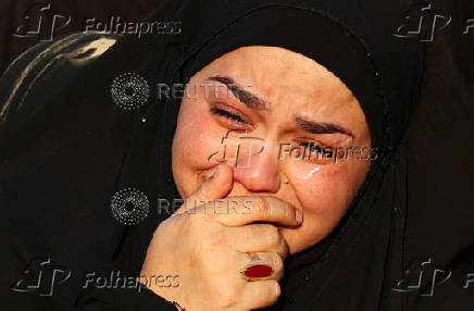 Volunteers re-enact a scene from the 7th-century Battle of Karbala to commemorate Ashura in Baghdad