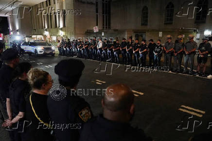 NYPD officers wait for the ambulance transfer of slain NYPD officer Didarul Islam