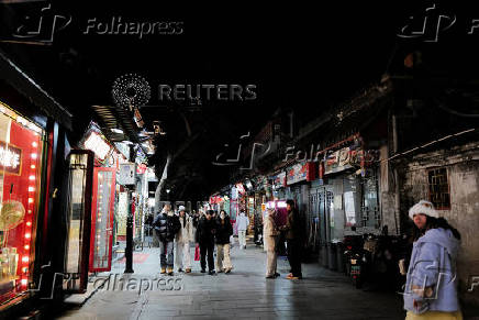 People walk in the Nanluoguxiang in Beijing