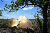 Members of the National Police Special Purpose Battalion fire howitzer towards Russian troops on a front line in Zaporizhzhia Region
