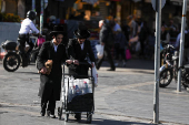 People shop in Jerusalem following an Israeli strike in Iran