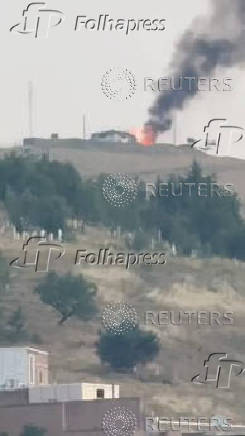 Smoke and flames rise, following Israeli strikes on Iran, in Piranshahr