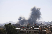 Smoke rises from a building after strikes at Syria's defense ministry in Damascus
